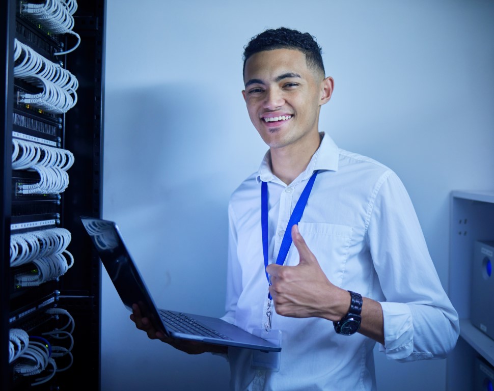 Man, thumbs up and server room on computer in cybersecurity, IT cables and hardware or data safety .
